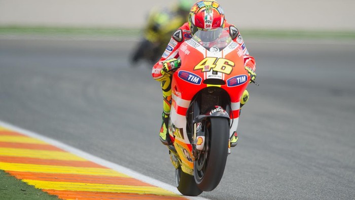 VALENCIA, SPAIN - NOVEMBER 05:  Valentino Rossi of Italy and Ducati Marlboro Team lifts the front wheel during the qualifying practice of the MotoGP of Valencia at Ricardo Tormo Circuit on November 5, 2011 in Valencia, Spain.  (Photo by Mirco Lazzari