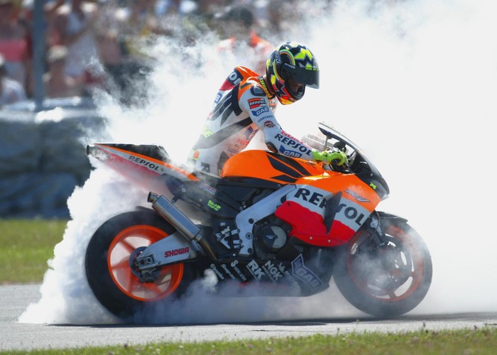 DONINGTON, ENGLAND - JULY 13:   Valentino Rossi of Italy and Repsol Honda celebrates winning the Cinzano British Moto GP on July 13, 2003 at Donington Park, England. (Photo by Clive Rose/Getty Images).