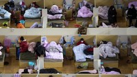 Begini penampakan sejumlah pasien yang terinfeksi virus corona. Mereka tampak beristirahat di tempat penampungan sementara ini. Xiao Yijiu/Xinhua via AP.