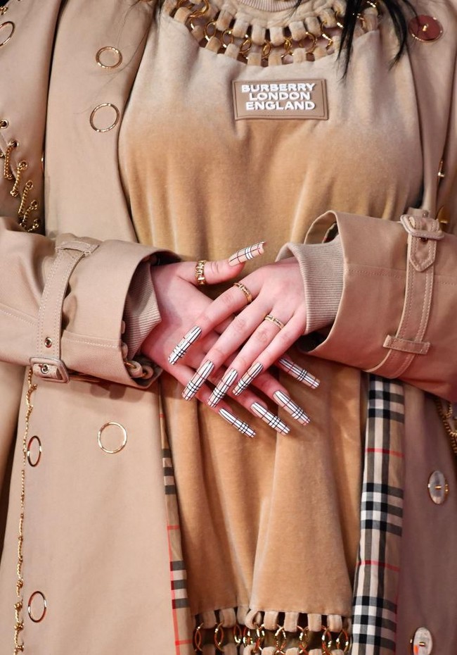 Sebagai sentuhan akhir, jari tangan Billie dihiasi kuku panjang yang dihiasi motif garis Burberry. (Foto: Gareth Cattermole/Getty Images)