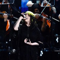 Gaya Billie Eilish lalu berubah total saat beraksi di panggung Brit Awards 2020 bersama Finneas dan komposer film Hans Zimmer. Melantunkan lagu No Time To Die yang merupakan soundtrack film James Bond terbaru, Billie memakai busana serba hitam. Selain sebagai performer, Billie juga berhasil menyabet penghargaan Brit untuk kategori International Female Solo Artist. (Foto: Gareth Cattermole/Getty Images)