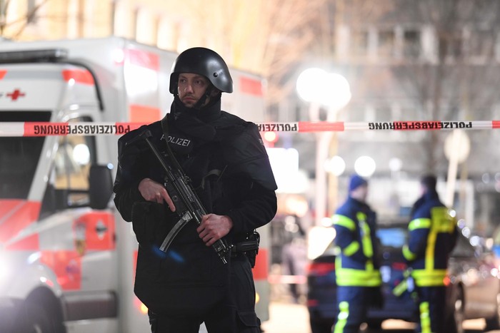 Penembakan Brutal di Jerman, 8 Orang Tewas Police handcuff a man near the scene of a shooting in Hanau, Germany early Thursday, Feb. 20, 2020. German police say several people were shot to death in the city of Hanau on Wednesday evening. (AP Photo/Michael Probst)