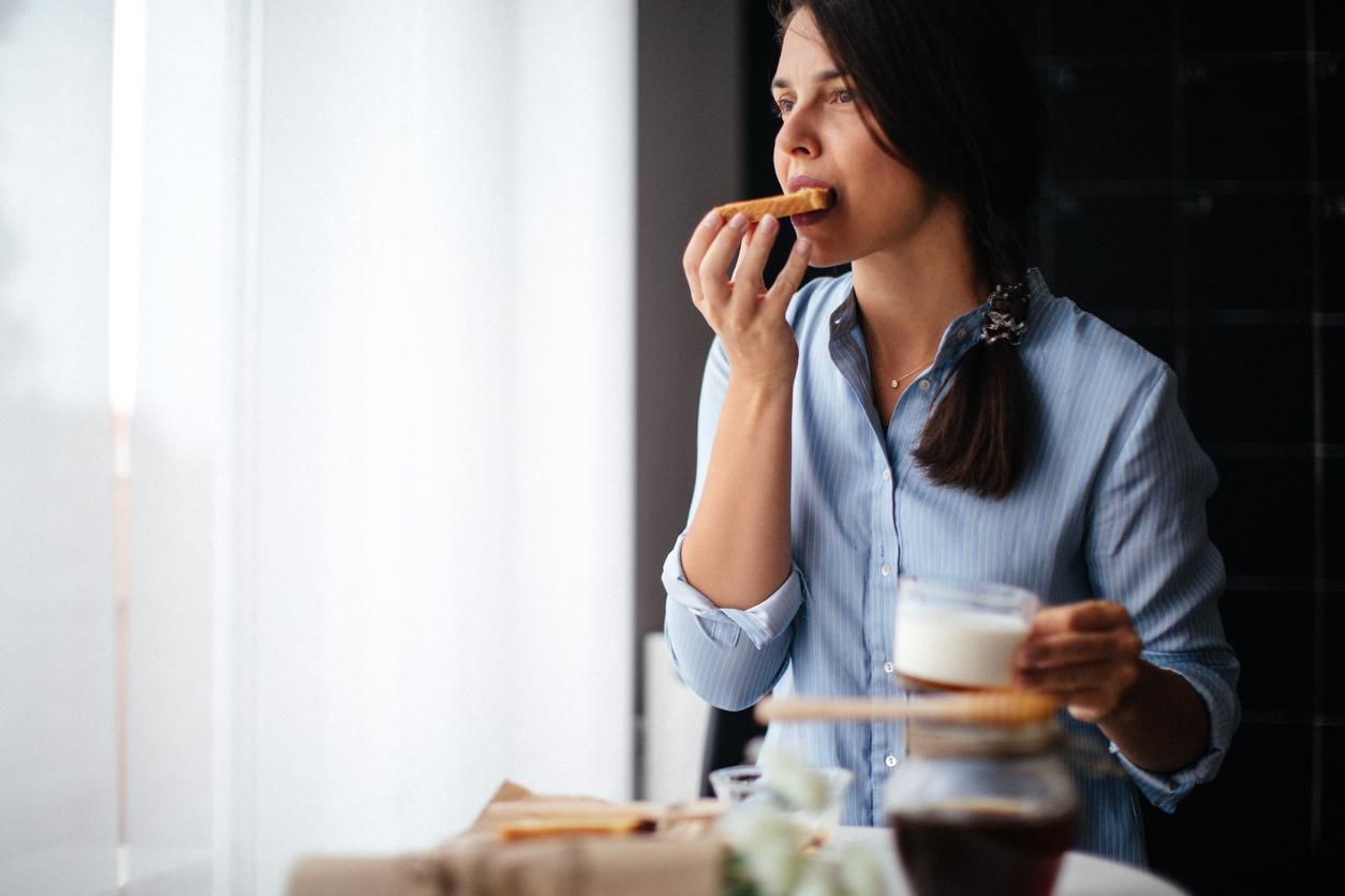 Woman eating honey on toasted bread