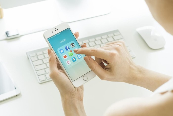 Istanbul, Turkey - March 20, 2016: Woman looking on social media applications on a brand new white Apple iPhone 6s, which is designed and developed by Apple inc. and was released on September 9, 2015.