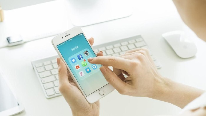 whatsapp Istanbul, Turkey - March 20, 2016: Woman looking on social media applications on a brand new white Apple iPhone 6s, which is designed and developed by Apple inc. and was released on September 9, 2015.