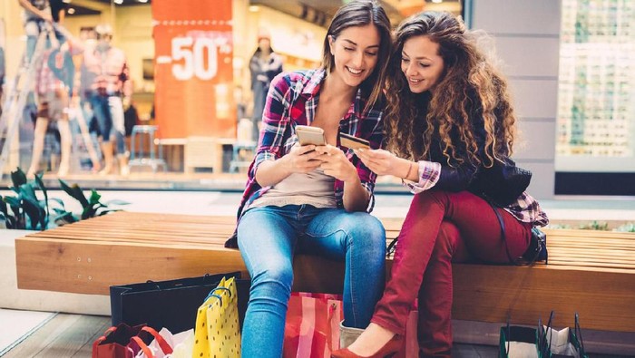 Smiling women shopping online with credit card