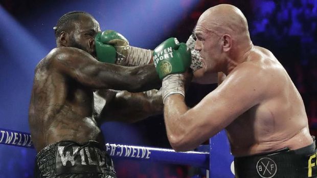 Tim Deontay Wilder menyerah di ronde ketujuh dengan melempar handuk.