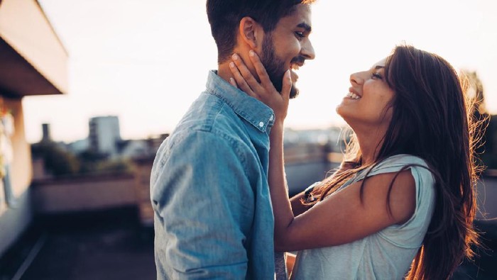 Beautiful young couple in love dating outdoors and smiling