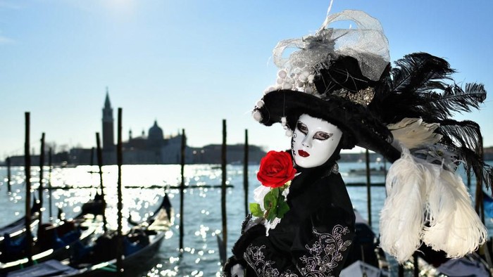 A reveller wearing a mask and a period costume takes part in the Venice Carnival on February 15, 2020. (Photo by Alberto PIZZOLI / AFP)