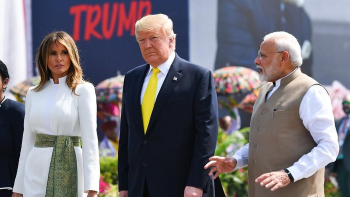 Indias Prime Minister Narendra Modi (R) speaks with US President Donald Trump (C) and First Lady Melania Trump (L) upon their arrival at Sardar Vallabhbhai Patel International Airport in Ahmedabad on February 24, 2020. (Photo by Mandel NGAN / AFP)