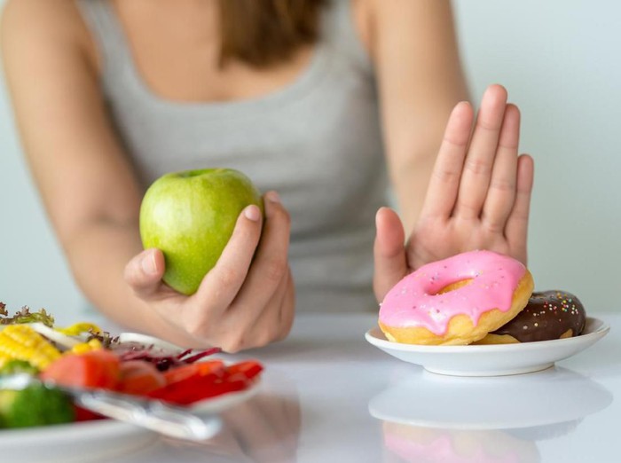 yoghurt Portrait of a casual woman at home eating a healthy breakfast and looking happy - lifestyle concepts