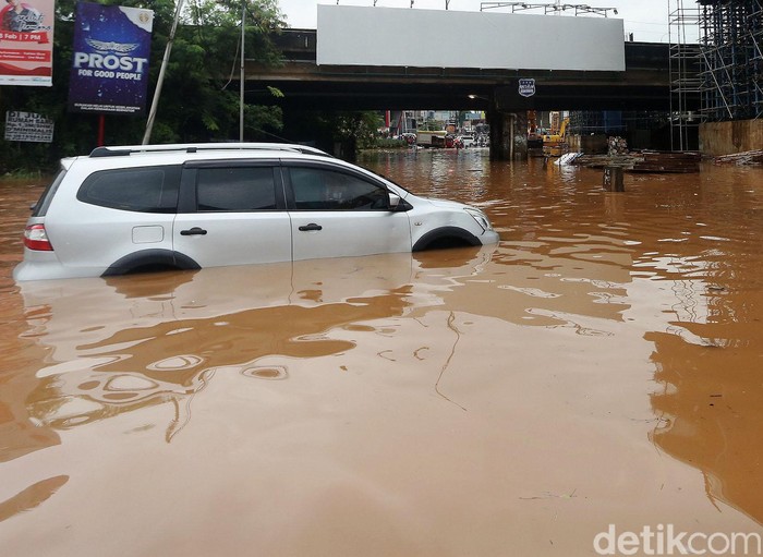 Mobil mogok ditengah banjir di Bawah Kolong Tol JORR Kalimalang, Kota Bekasi, Jawa Barat, Selasa (25/2/2020). Jalan Drainase yang buruk dan hujan deras yang terus mengguyur wilayah Kota Bekasi dan sekitarnya, mengakibatkan banjir dan menyulitkan akses warga bekasi menuju Jakarta maupun sebaliknya .