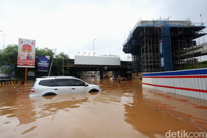 Mobil mogok ditengah banjir di Bawah Kolong Tol JORR Kalimalang, Kota Bekasi, Jawa Barat, Selasa (25/2/2020). Jalan Drainase yang buruk dan hujan deras yang terus mengguyur wilayah Kota Bekasi dan sekitarnya, mengakibatkan banjir dan menyulitkan akses warga bekasi menuju Jakarta maupun sebaliknya .