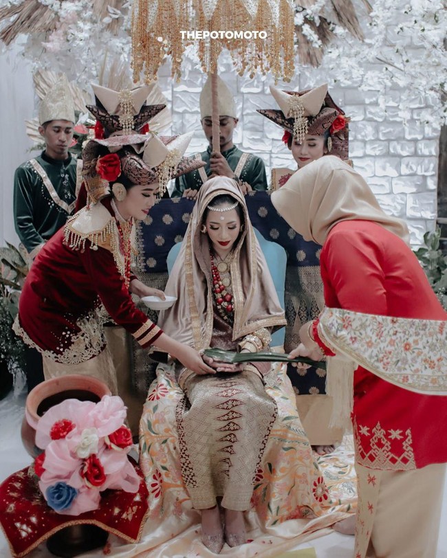 Persiapan malam Bainai dimulai dari jam tiga sore, yang sebenarnya acara mulai di jam delapan malam. Aku sengaja untuk dandan sangat lebih awal karena aku mau dandan dengan tenang dan tidak terburu-buru. Memulai dengan bismillah, aku dandan dan mencoba untuk fokus, tulisnya. Foto: Instagram @abellyc, @thepotomoto