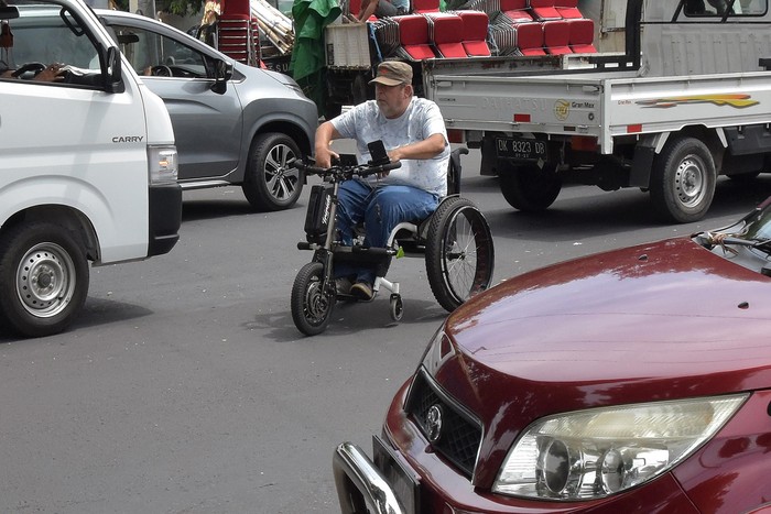 Seorang warga negara asing mengendarai kursi roda elektrik tanpa menggunakan helm, di Denpasar, Bali, Rabu (26/2/2020). Dinas Pariwisata Provinsi Bali sebelumnya telah meminta pihak kepolisian menertibkan warga asing yang ugal-ugalan di jalan dan melakukan pelanggaran lalu lintas. ANTARA FOTO/Nyoman Hendra Wibowo/nym/ama.