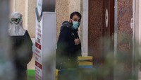 Seorang warga yang berhasil dievakuasi dari Iran tampak mengenakan masker saat memasuki Rumah Sakit Dr. Zekai Tahir Burak di Ankara, Turki. Getty Images.