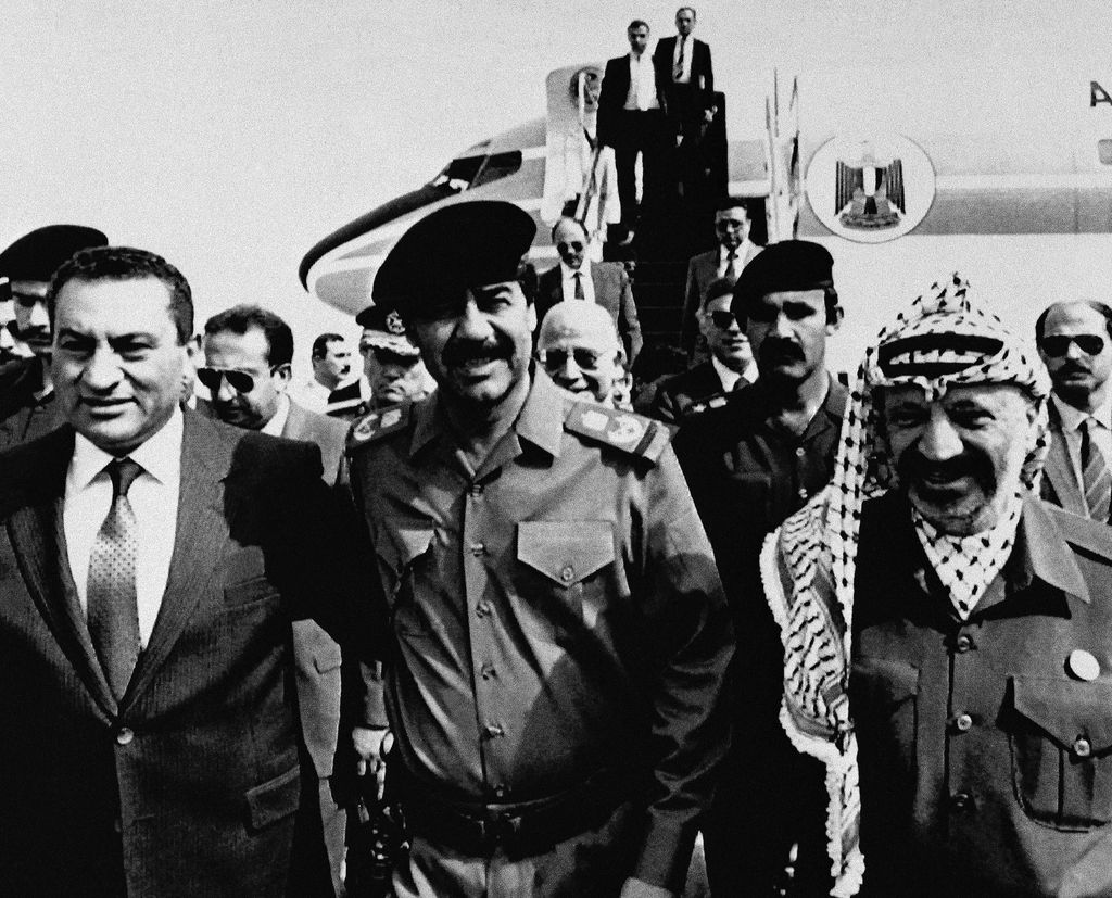 FILE - In this Oct. 24, 1988 file photo, Iraqi President Saddam Hussein, center, greets President Hosni Mubarak, left, and Palestinian Liberation Organization Chairman Yasser Arafat for talks aimed at a coordinated Arab position on Middle East peace, in Baghdad, Iraq. Egypt's State TV said Tuesday, Feb. 25, 2020, that Mubarak, who was ousted in the 2011 Arab Spring uprising, has died at 91. Mubarak ruled the most populous Arab country for nearly three decades, serving as a loyal U.S. ally against Islamic militancy and assisting regional peace efforts. But his autocratic rule grew increasingly unpopular in his later years, and he was forced to resign on Feb. 11, 2011, after 18 days of mass protests. (AP Photo, File)