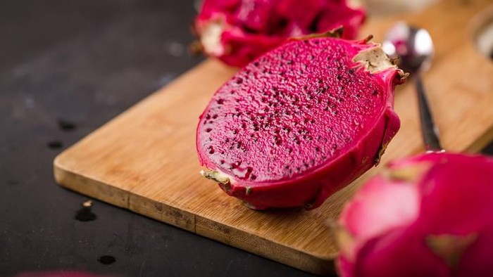 Pitaya cut in half on black background