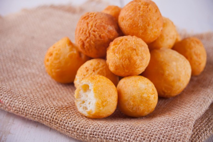 Small balls of freshly baked homemade cottage cheese doughnuts on the jute napkin
