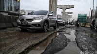 Sejumlah kendaraan melintas di Jalan Boulevard yang rusak parah.