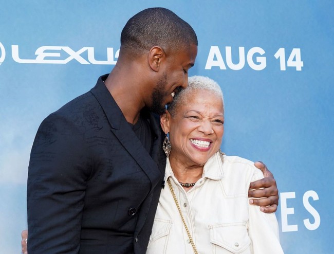 Michael B. Jordan mendaratkan kecupan sayang ke pipi sang bunda, Donna Jordan, saat hadir di Academy Awards. Cute! Foto: Rachel Luna/Getty Images