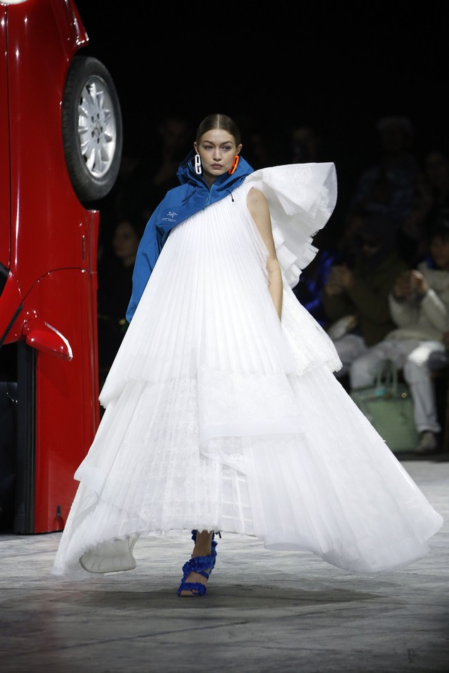  Gigi Hadid memberikan penampilan penuh drama dengan gaun putih A-line yang megar dari label favorit kaum hypebeast itu. Gaun tersebut dipadukan dengan cropped jacket asimetris biru. Foto: Getty Images/Thierry Chesnot