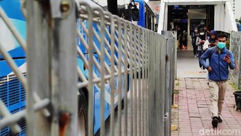 Para pekerja tampak lalu lalang di jalur pedestrian Ibu Kota.