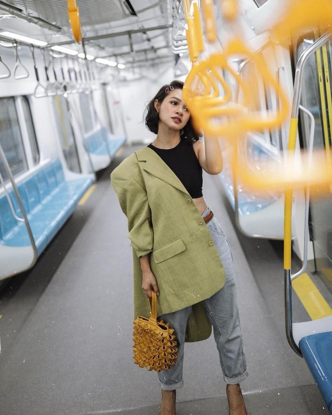 Andien Aisyah terlihat berfoto menggunakan crop top hitam, celana jeans dan blazer hijau muda. Tidak lupa Andien melengkapi gayanya dengan tas bertekstur warna kuning. Foto: Instagram @andienaisyah