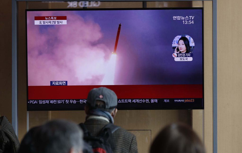 People watch a TV screen showing a news program reporting about North Korea's firing of projectiles with a file image at the Seoul Railway Station in Seoul, South Korea, Monday, March 2, 2020. North Korea fired two unidentified projectiles into its eastern sea on Monday as it begins to resume weapons demonstrations after a months-long hiatus that could have been forced by the coronavirus crisis in Asia. The Korean letters read: 