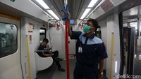 Petugas membersihkan bagian dalam gerbong LRT rute Velodrome-Kelapa Gading.
