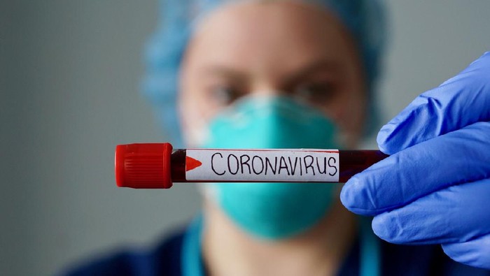 Nurse wearing respirator mask holding a positive blood test result for the new rapidly spreading Coronavirus, originating in Wuhan, China