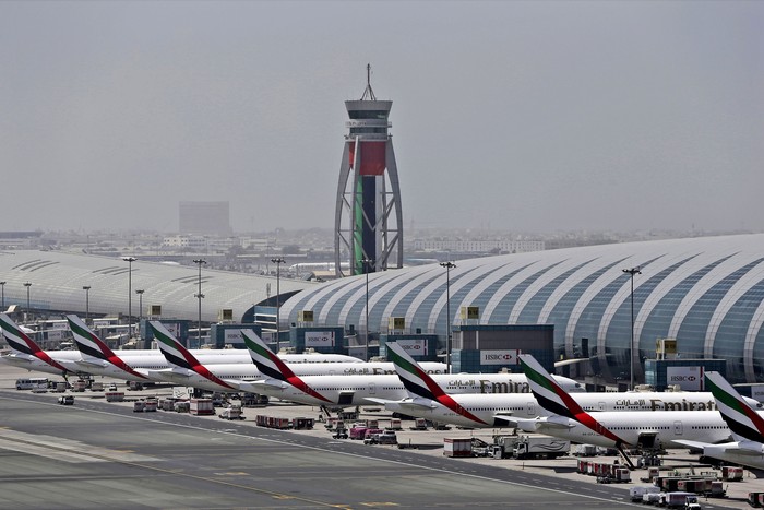 FILE - In this April 20, 2017 file photo, Emirates planes are parked at the Dubai International Airport in Dubai, United Arab Emirates. Major disruptions due to the new coronavirus have already caused the equivalent of a roughly $100 million loss to airline carriers in the Middle East region, which serves as a connection hub for east-west travel, the industrys main trade association said on Monday, March 2, 2020. (AP Photo/Kamran Jebreili, File)