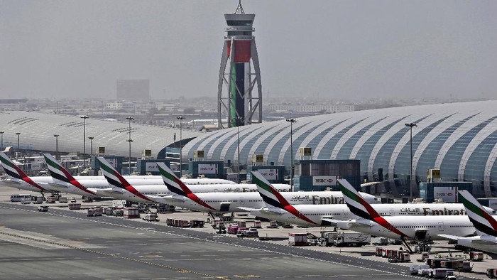 FILE - In this April 20, 2017 file photo, Emirates planes are parked at the Dubai International Airport in Dubai, United Arab Emirates. Major disruptions due to the new coronavirus have already caused the equivalent of a roughly $100 million loss to airline carriers in the Middle East region, which serves as a connection hub for east-west travel, the industrys main trade association said on Monday, March 2, 2020. (AP Photo/Kamran Jebreili, File)