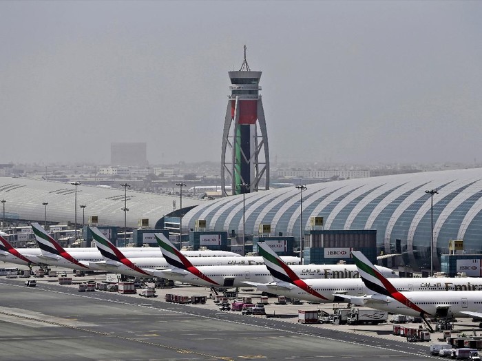 FILE - In this April 20, 2017 file photo, Emirates planes are parked at the Dubai International Airport in Dubai, United Arab Emirates. Major disruptions due to the new coronavirus have already caused the equivalent of a roughly $100 million loss to airline carriers in the Middle East region, which serves as a connection hub for east-west travel, the industrys main trade association said on Monday, March 2, 2020. (AP Photo/Kamran Jebreili, File)