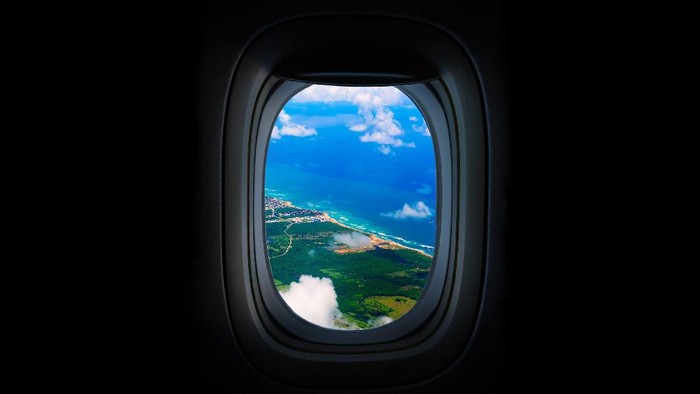 Costline, sea and sky from the airplanes Porthole. Dominican Republic