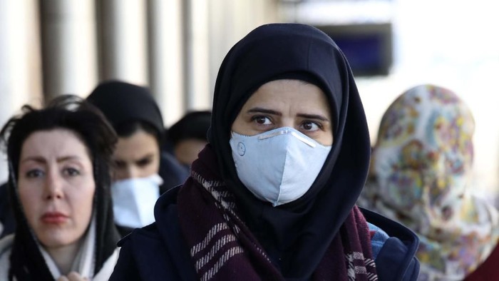 Some women wear face masks as they walk in downtown Tehran, Iran, Monday, March 2, 2020. A member of a council that advises Irans supreme leader died Monday after falling sick from the new coronavirus, becoming the first top official to succumb to the illness striking both citizens and leaders of the Islamic Republic. (AP Photo Vahid Salemi)