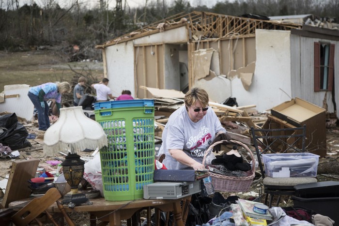 In this Tuesday, March 3, 2020 photo, Henry Watts works to remove debris from his home after a tornado ripped through the Stanford Estates Neighborhood near Donelson Christian Academy in Nashville, Tenn. (George Walker IV/The Tennessean via AP)