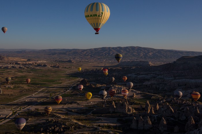 NEVSEHIR, TURKEY - APRIL 17:  Tourists ride hot air balloon near the town of Goreme on April 17, 2016 in Nevsehir, Turkey. Cappadocia, a historical region in Central Anatolia dating back to 3000 B.C is one of the most famous tourist sites in Turkey. Listed as a World Heritage Site in 1985, and known for its unique volcanic landscape, fairy chimneys, large network of underground dwellings and some of the best hot air ballooning in the world, Cappadocia is preparing for peak tourist season to begin in the first week of May.  Despite Turkey's tourism downturn, due to the recent terrorist attacks,  internal instability and tension with Russia, local vendors expect tourist numbers to be stable mainly due to the unique activities on offer and unlike other tourist areas in Turkey such as Antalya, which is popular with Russian tourists, Cappadocia caters to the huge Asian tourist market.  (Photo by Chris McGrath/Getty Images)