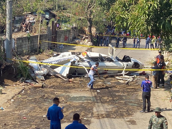 The site of a helicopter crash is cordoned off in San Pedro, Laguna province, south of Manila, Philippines Thursday, March 5, 2020.  The helicopter carrying the Philippine national police chief and other people crashed Thursday, officials said. (AP Photo/Aaron Favila)