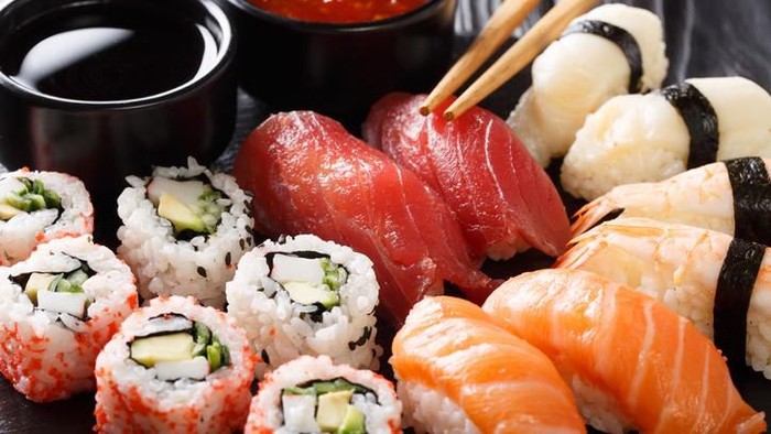 Big futomaki sushi with salmon, prawn tempura and cucumber