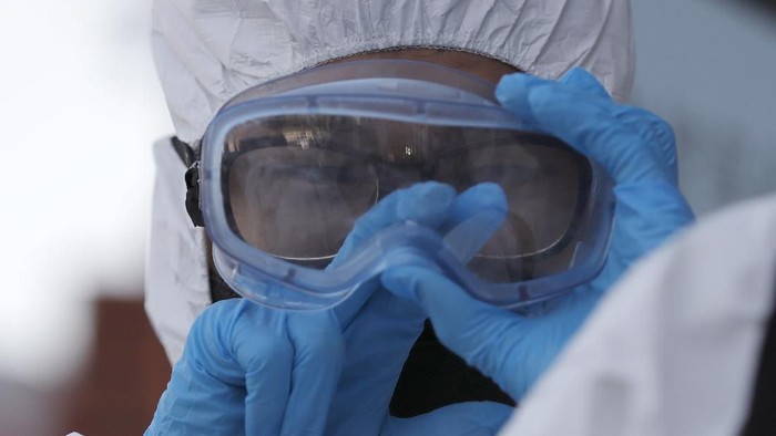 A South Korean soldier wearing protective gears cleans his goggles to spray disinfectant as a precaution against the new coronavirus on a street in Seoul, South Korea, Friday, March 6, 2020. South Koreas premier has criticized Japans 14-day quarantine on all visitors from South Korea due to its viral outbreak, demanding that Tokyo immediately withdraw the 