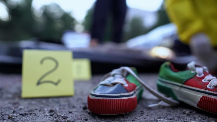 1158848598 Child snickers marking as evidence, experts working on crime scene, car accident