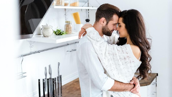 640097466 Cropped shot of an affectionate young couple relaxing at home