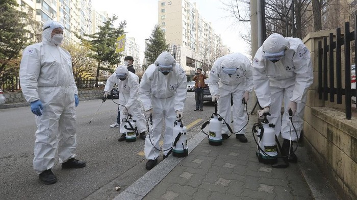 South Korean army soldiers prepare to spray disinfectant as a precaution against a new coronavirus on a street in Seoul, South Korea, Monday, March 9, 2020. (AP Photo/Ahn Young-joon)