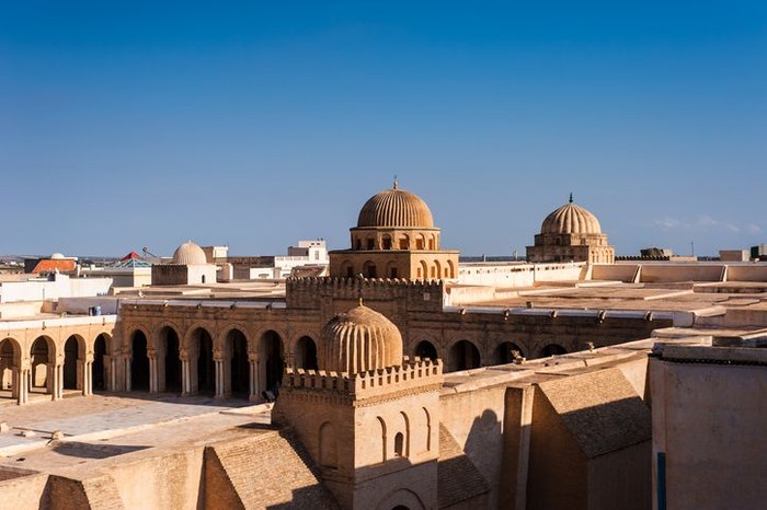 Kairouan, Tunisia - August 30, 2015: The medieval shady covered terrace of the Grand Mosque consists of many raws of columns that support the arches and ceiling.