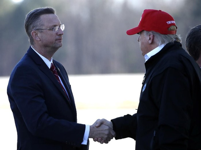 President Donald Trump greets Rep. Doug Collins, R-Ga., as he arrives on Air Force One Friday, March 6, 2020, at Dobbins Air Reserve Base in Marietta, Ga. (AP Photo/Alex Brandon)