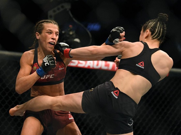 1211098965 LAS VEGAS, NEVADA - MARCH 07: Joanna Jedrzejczyk punches Weili Zhang in a split decision loss during a strawweight title bout at T-Mobile Arena on March 07, 2020 in Las Vegas, Nevada. (Photo by Harry How/Getty Images)