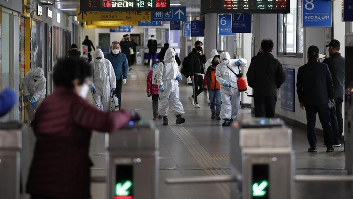 Workers wearing protective gears disinfect as a precaution against the new coronavirus at the subway station in Seoul, South Korea, Friday, March 13, 2020. For most people, the new coronavirus causes only mild or moderate symptoms, such as fever and cough. For some, especially older adults and people with existing health problems, it can cause more severe illness, including pneumonia. (AP Photo/Lee Jin-man)