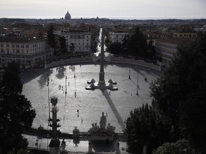 A view of an almost deserted Piazza del Popolo square in Rome, Thursday, March 12, 2020. A sweeping lockdown is in place in Italy to try to prevent it from becoming the next epicenter of the coronavirus epidemic. For most people, the new coronavirus causes only mild or moderate symptoms. For some, it can cause more severe illness, especially in older adults and people with existing health problems. (AP Photo/Alessandra Tarantino)