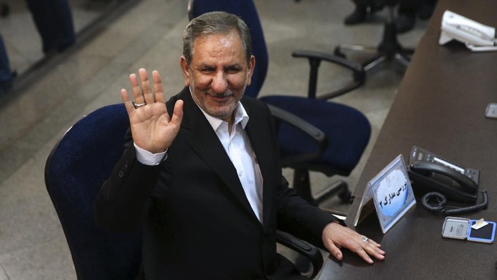 CORRECTS FIRST NAME TO ESHAQ: FILE - In this April 15, 2017 file photo, Iranian Vice-President Eshaq Jahangiri waves to media while registering his candidacy for the May 19, 2017, presidential elections, at the Interior Ministry, in Tehran, Iran. Jahangiri and two other Cabinet members have contracted the new coronavirus, semiofficial Fars News Agency reported Wednesday, March 11, 2020. The vast majority of people recover from the new virus. (AP Photo/Vahid Salemi, File)